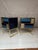 The bedside tables, with their blue and gold glass surfaces, convey a sense of freshness and elegance. Refined brass...