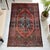 This vintage Persian Sarouk hand‑knotted rug displays a central medallion with floral and vine motifs set within a richly...