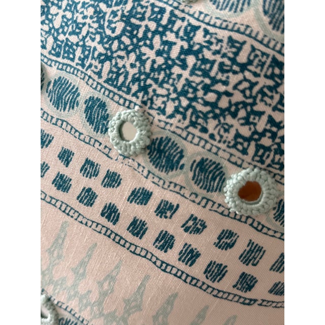 Beautiful soft white and turquoise pillow will add a hint of boho to any space. Mirror and embroidery embellishment detail...