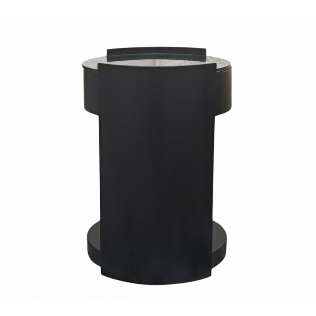 Bedside table/side table with wheels featuring a cylindrical structure in black lacquered wood, enhanced by a glass top...