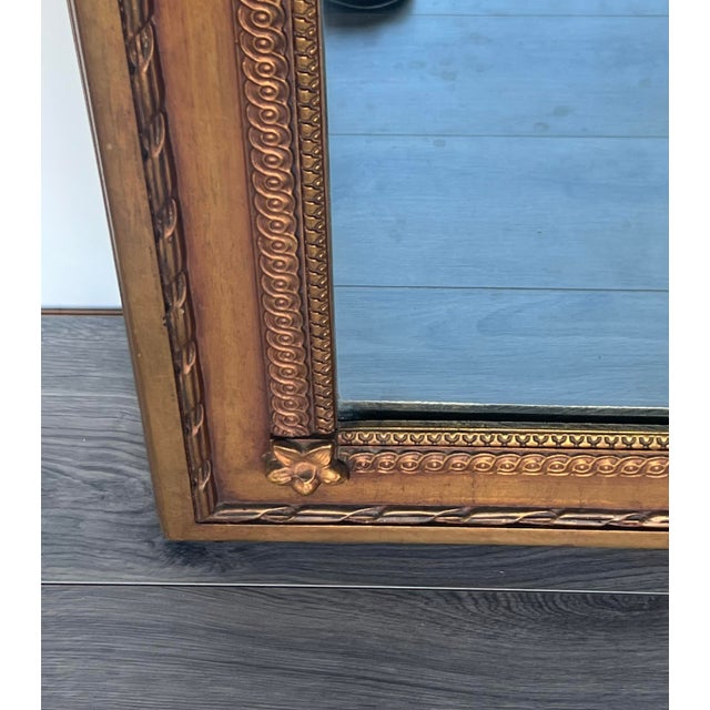 Louis XVI style gilded mirror This mirror is in great vintage condition Dimensions: 38” Width x 1.5” Depth x 54”Height See...