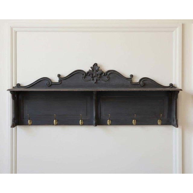 This beautifully decorated antique wall-mounted coat rack originates from Sweden and dates to the early 20th century,...