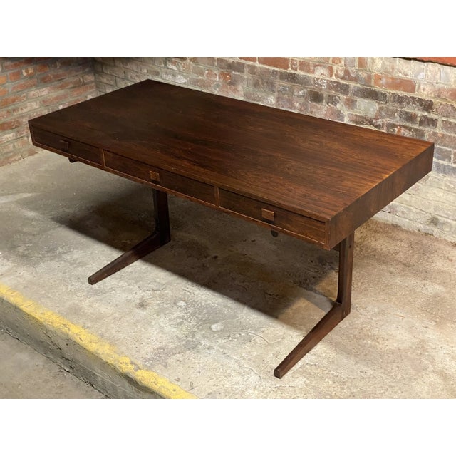 Georg Petersens design rosewood cantilever desk. Circa 1970. This beautiful desk features: exquisitely figured and matched...