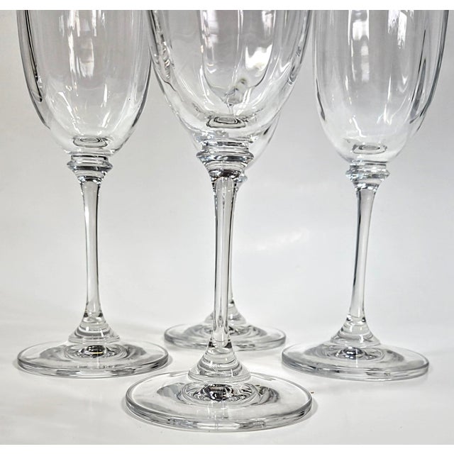 This incredibly dainty and delicate set of champagne flutes is sheer perfection. The wavy crystal bowls create an effect...