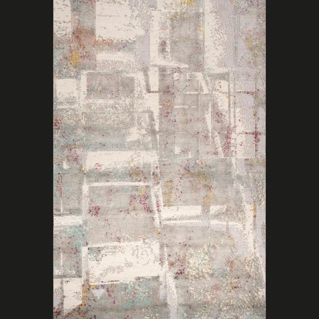 Crafted in India using a mixture of techniques; Loop, Kilim and Sumak and Tibetan 100 line knot, this exquisite Rug...