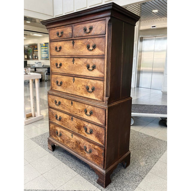 This antique George III chest-on-chest was hand-crafted in the 19th Century from mahogany wood with brass bail pulls and...