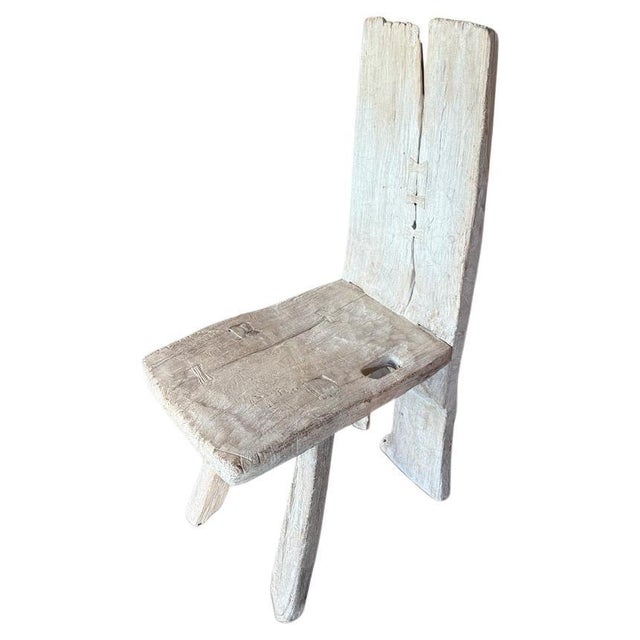 Century old unique sculptural chair. The back is a single piece of ancient teak wood. We added butterflies across the...