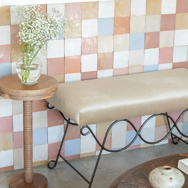 Iron bench with beautiful curved and looped base with matte black painted finish. Rectangular cushioned seat upholstered...