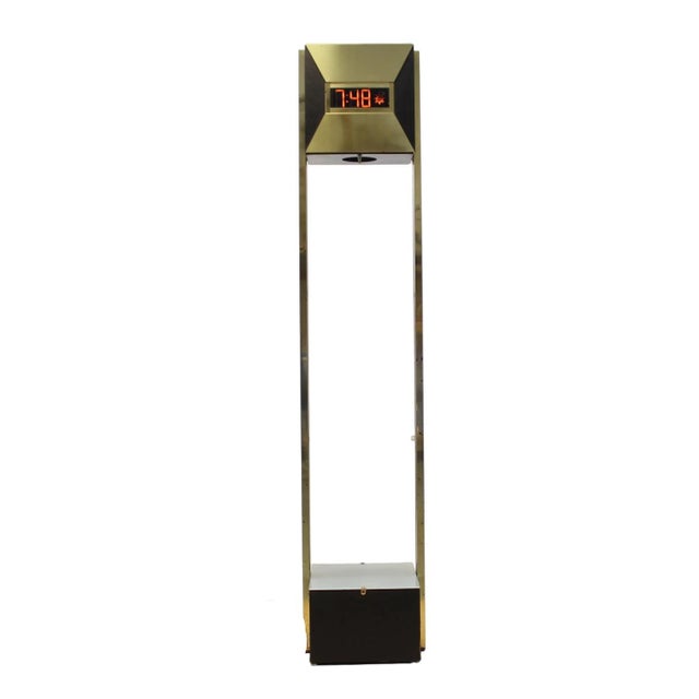 1970s modern brass-toned tower clock with a classic digital display at the top and a built-in uplight at the base which...