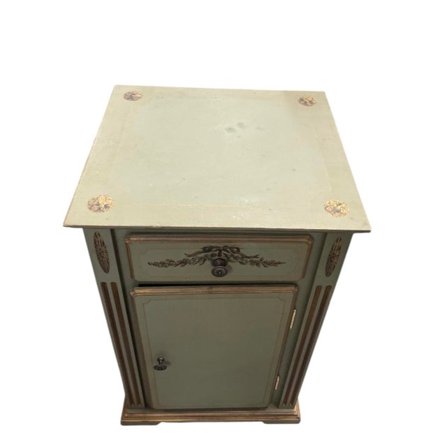 This French Neoclassical-style accent cabinet brings understated classic elegance to a bedroom, entryway, or living room...