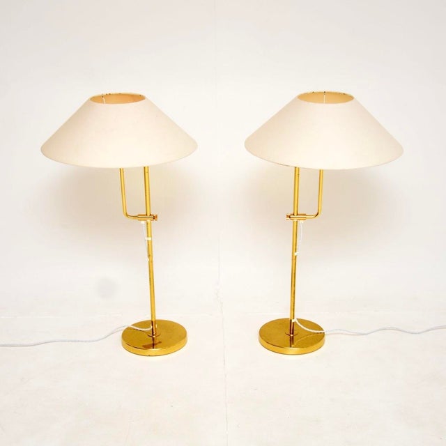 A stunning pair of vintage Swedish brass rise and fall lamps by Bergboms. They were recently imported from Sweden, they...