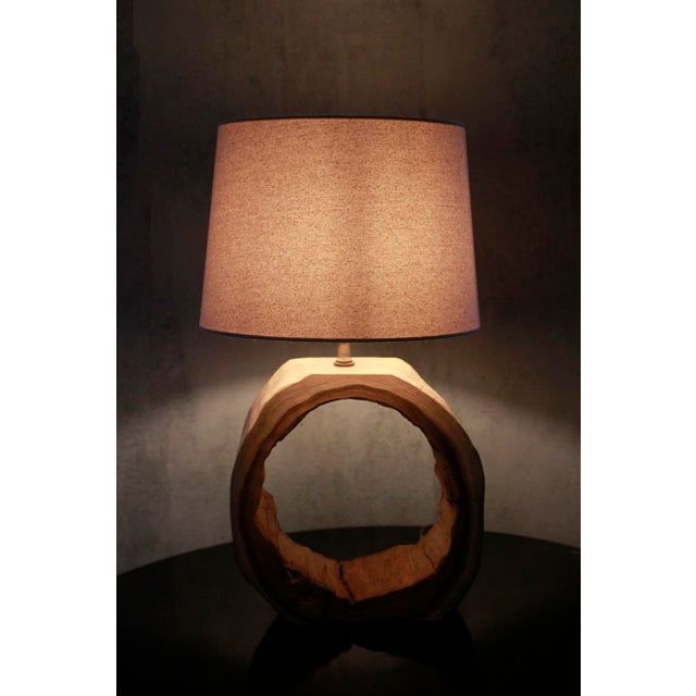 This rustic, circular table lamp crafted from Teak wood adds warmth and charm to any space. Its durable construction...