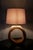 This rustic, circular table lamp crafted from Teak wood adds warmth and charm to any space. Its durable construction...