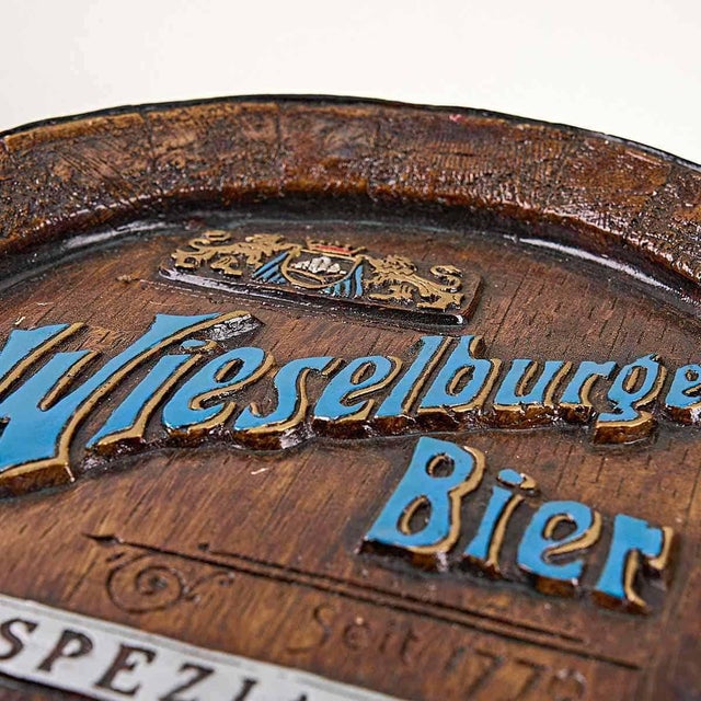 Vintage wieselburger beer gadget in plaster wall Height: 4.5 Diameter: 40. This piece is attributed to the mentioned...