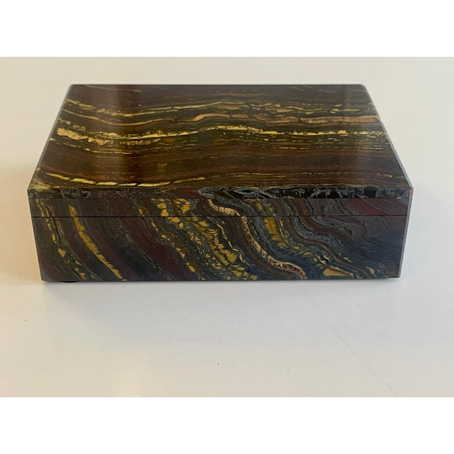Handcrafted, spectacular box made of tiger iron, which is highly valued for its healing properties. The colors shift...