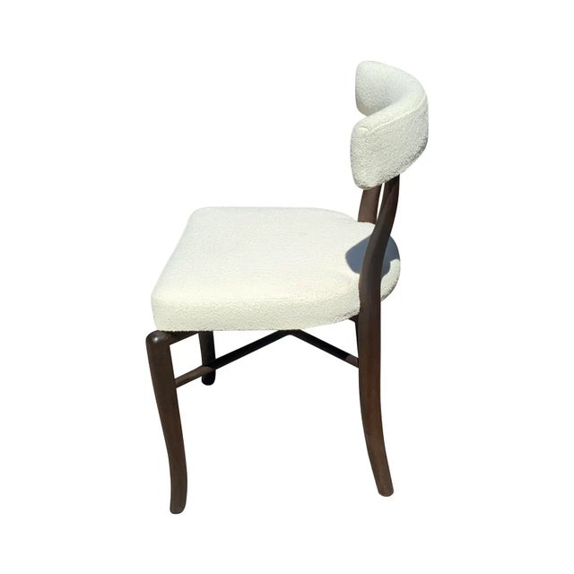 Mid century style dining chairs. Set of 6 armless chairs are done in a cream Boucle. The wood is solid walnut. The set of...