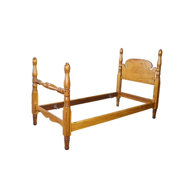 Pair of vintage Early American colonial-style twin beds crafted from solid maple wood. Features a vibrant, honey-toned...