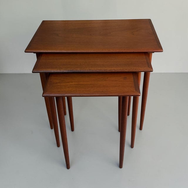 Elegant set of three Danish Mid-Century Modern nesting tables dating from the 1960s. Crafted in teak, the tables feature...