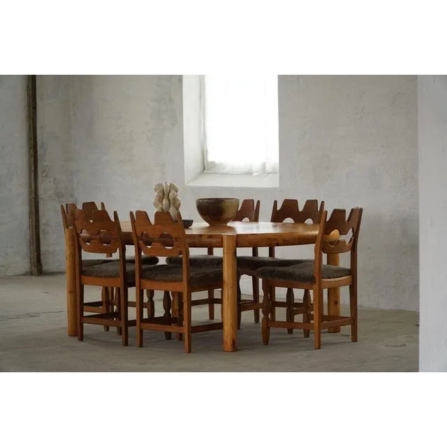 A bold and sculptural set of six oak dining chairs, designed by Henning (Henry) Kjærnulf for Nyrup Møbelfabrik in Denmark...