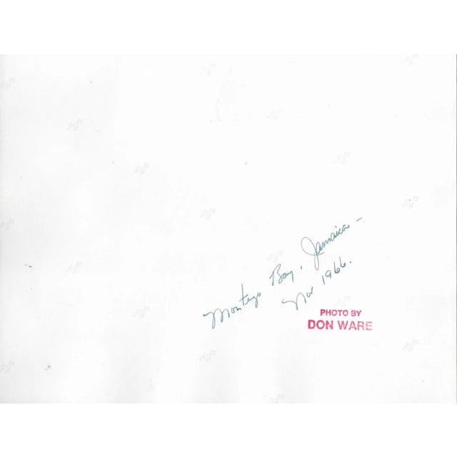 1966 black and white photo by Don Ware (1921-2006) of a Jamaican beach and sail boat. Titled and dated; bearing Ware's...