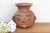 This terracota vase is a captivating anthropomorphic vessel that pays homage to the sophisticated ceramic traditions of...