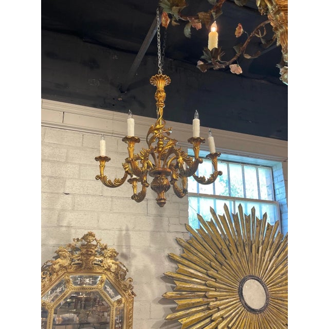 Handsome vintage Italian gilt 6 light chandelier. Beautiful decorative arms and great scale and shape. A classic look that...