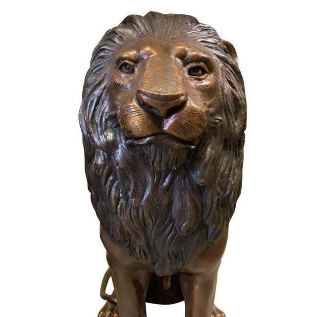 This is a very interesting patinated bronze sculpture of a pair of lions, late 20th century in dater. They are sitting up...