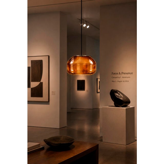 Crafted with high visual clarity, this modern pendant lamp features a sleek silhouette hand-blown from premium glass in a...