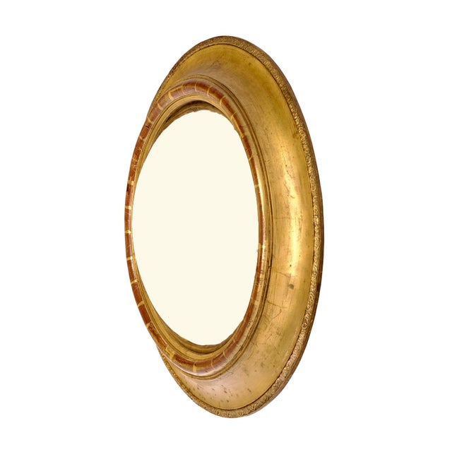Circular convex mirror from France. This mirror has a wood frame that has the original gold leafing and patina. The...