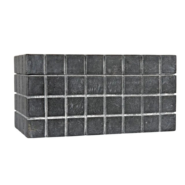 A black marble box is hand etched with a grid pattern on five sides, juxtaposing the beautiful variety of natural stone...