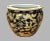 Hand-painted Asian porcelain fishbowl planter featuring traditional figural scenes and architectural motifs. The exterior...