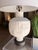 This contemporary table lamp makes a striking statement with its sculptural textured base and clean, modern silhouette....
