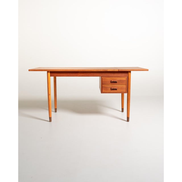 Teak frame with extendable top, two sliding drawers, and tapered legs; the fold-down side extension measures 39.5 cm....