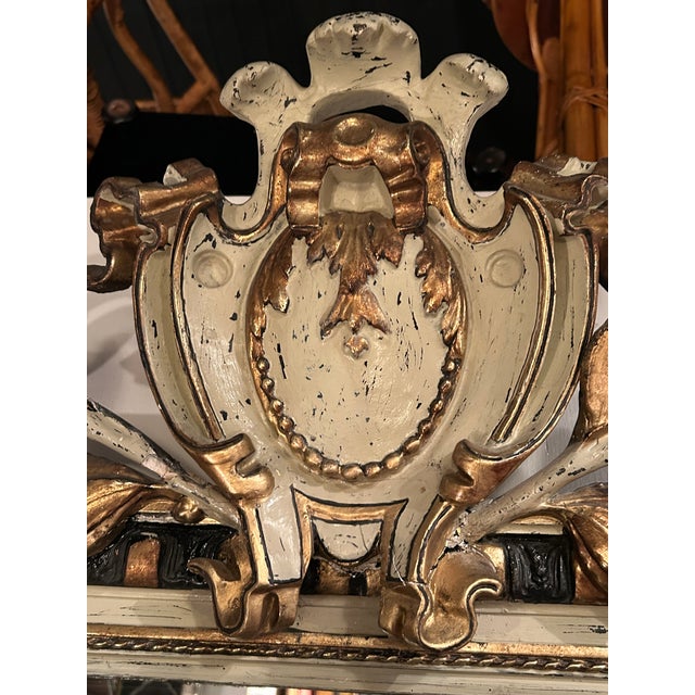 Magnificent and impressive in scale French Napoleon III mirror having gray original paint, ebonized black and gold on the...