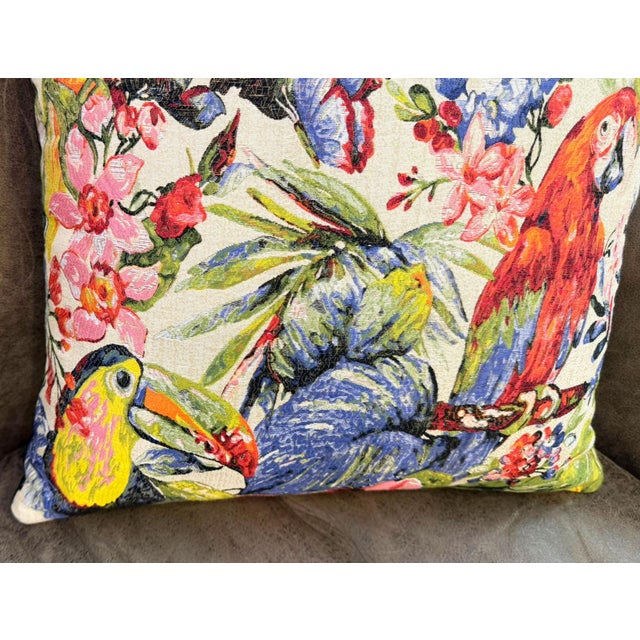 A scarlet macaw perches on the right. A toucan faces left from the lower corner. A yellow parrot pushes through tropical...