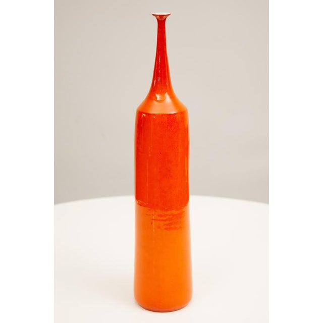 Hand-thrown earthenware small neck vase with multi-layered warm orange/selenium glaze. Decorative shaped ceramic vase...