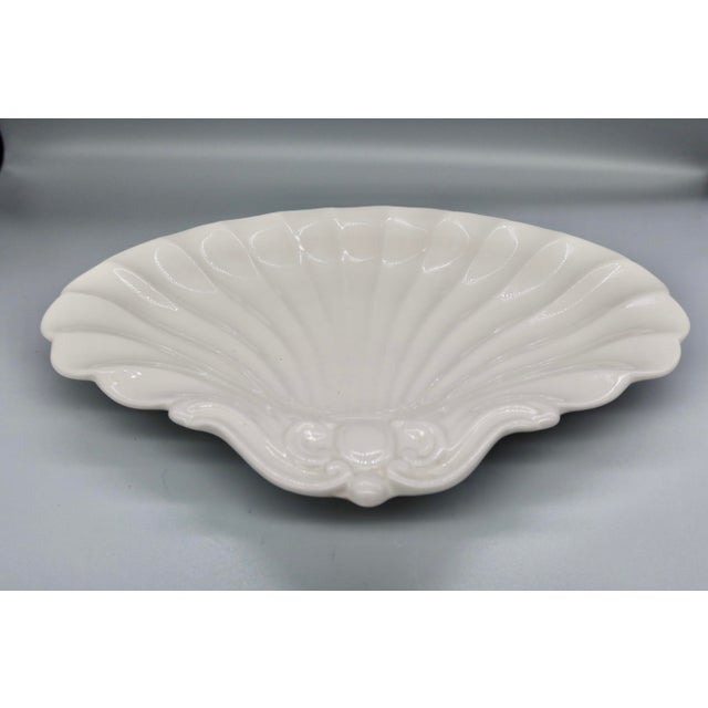 A classic white glazed scallop shell dish from Spode's Imperial line, made in England. The fluted, radiating shell design...