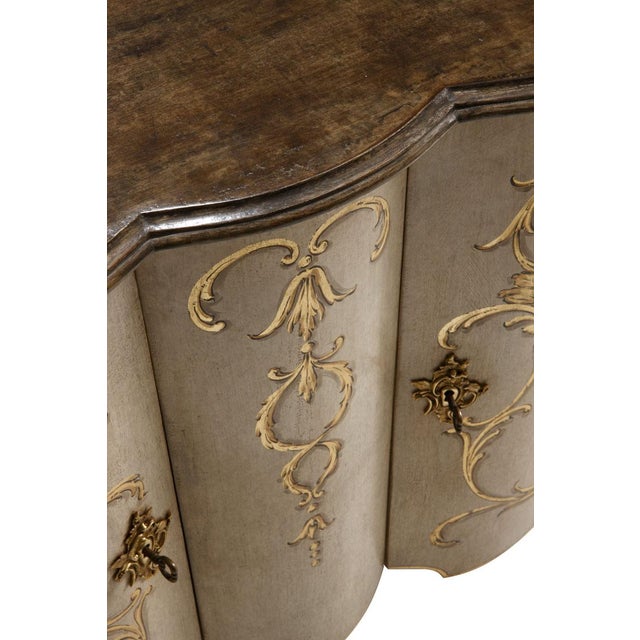 Handcrafted in Italy from solid wood, this Florentine credenza features an antique white rub-through finish accented by...