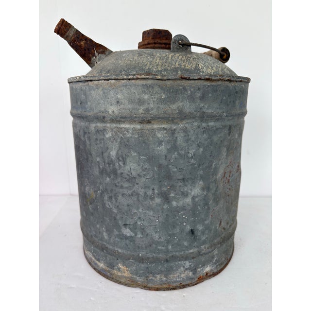 Bring industrial charm and authentic age to your décor with this early 20th-century galvanized metal oil can, featuring...