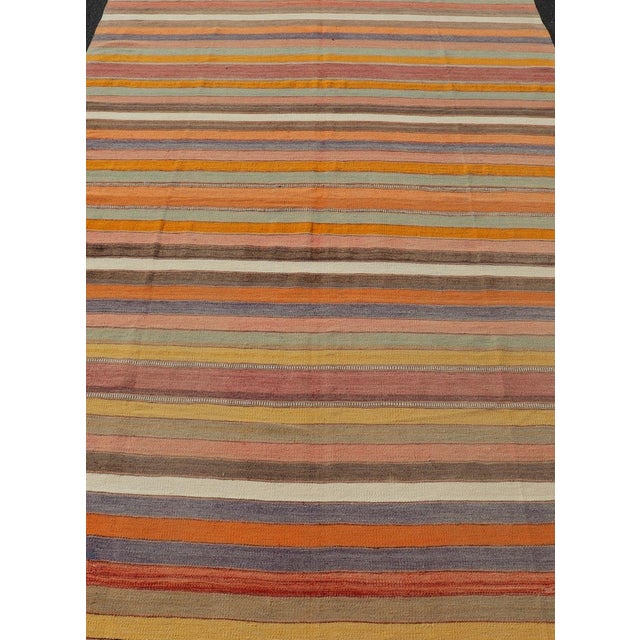 Vintage Striped Turkish Kilim in Multi Colors by Keivan Woven Arts. Measures: 6'6 x 10'7 This stunning vintage Turkish...