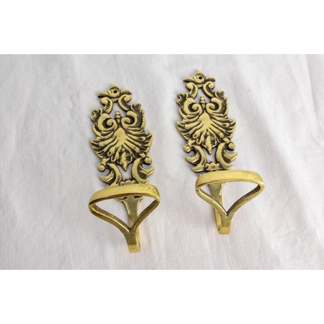 Pair of bronze wall coat hooks, circa 1960 Pair of decorative gilded bronze wall coat hooks, made in France in the 1960s....