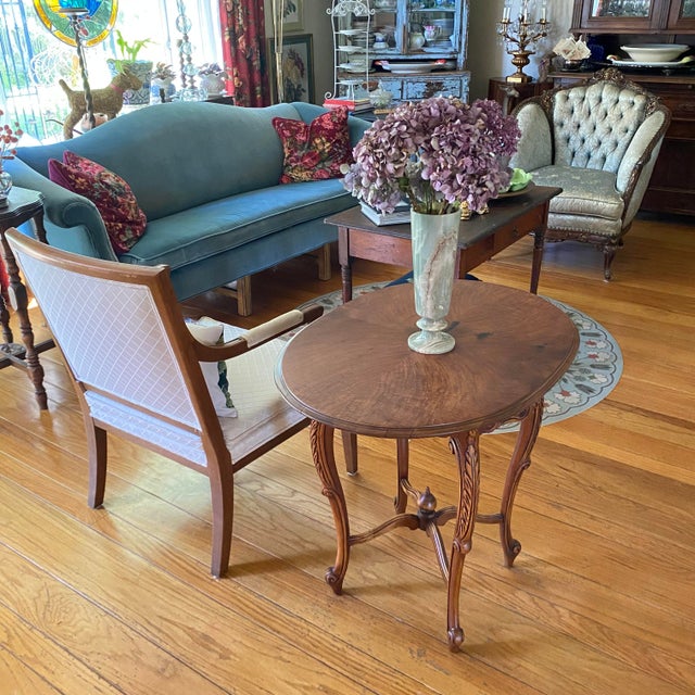 Table features four deeply curved, S-shaped cabriole legs detailed with carved acanthus leaf motifs running down the...