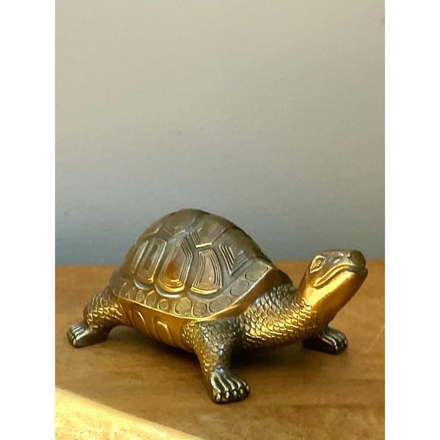 This vintage burnished brass turtle brings a warm, sculptural note to a shelf, console, or tabletop. Its shell is marked...