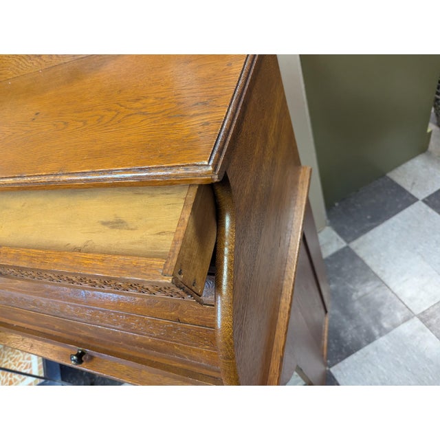 Vintage Oak Rolltop Desk. Two drawers, pull out leather top writing area with multiple storage compartments inside. The...
