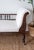 A graceful chaise longue in carved oak with a single scrolled back, dating to the late nineteenth or early twentieth...