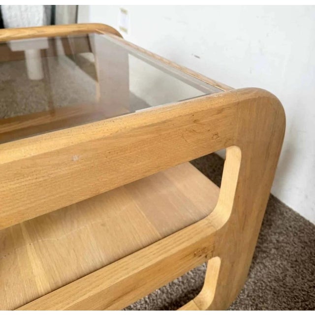 A sculptural pair of Mid Century Modern oak side tables attributed to Lou Hodges, showcasing beautifully softened...