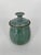 Beautiful glossy dripped blue glazed art pottery lidded jar with green speckles. Bottom is signed by the artist....