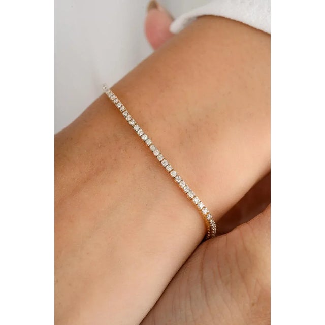 This Natural 1.25 Carat Round Diamond Stackable Tennis Bracelet in 18K gold showcases sparkling natural diamonds, weighing...