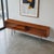 Attributed to Ib Kofod-Larsen for Brande Møbelfabrik, this exceptional Danish Modern teak display console embodies the...