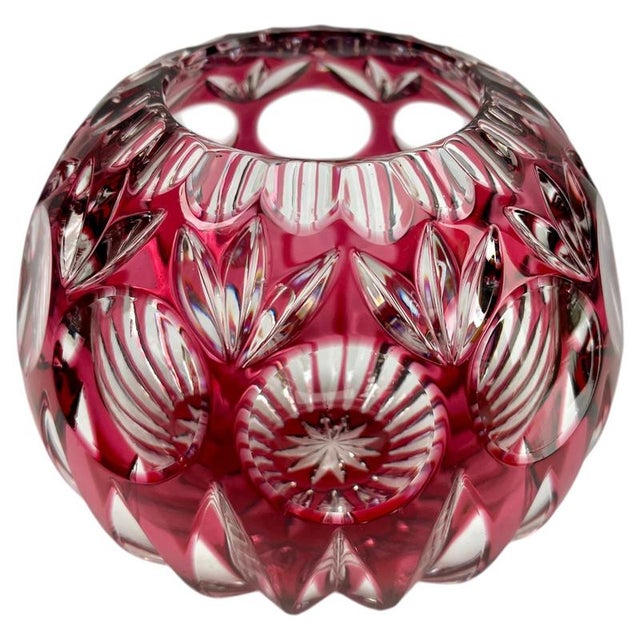 This is a ruby-red Bohemian crystal globe vase, beautifully decorated with intricate star-shaped cut patterns that reveal...